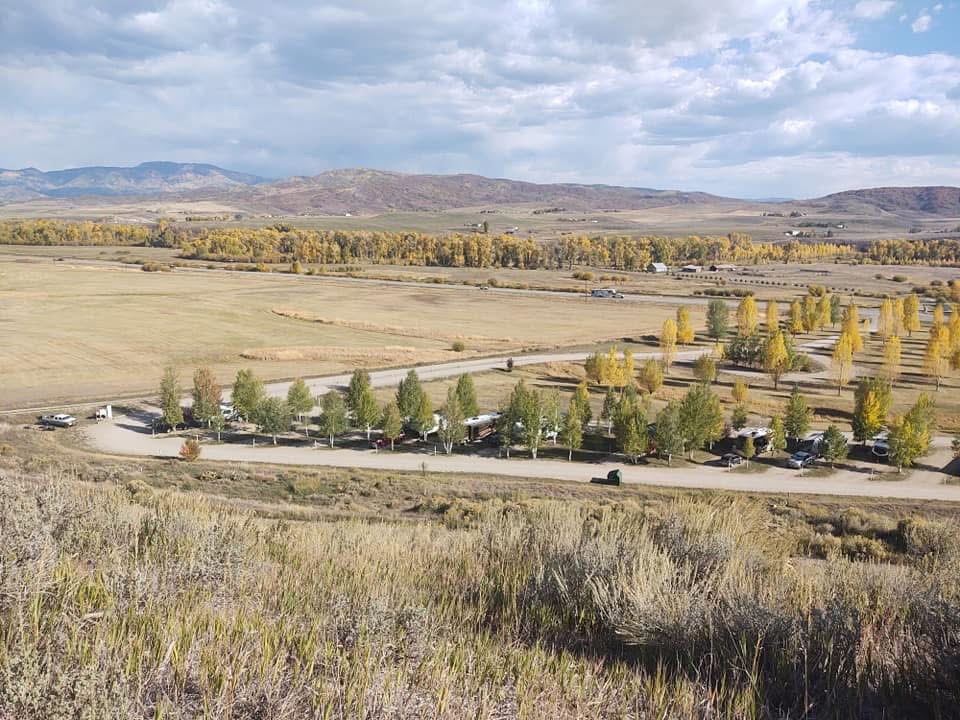 Aerial view of RV sites lined with golden aspen trees in autumn at Eagle Soaring RV Park